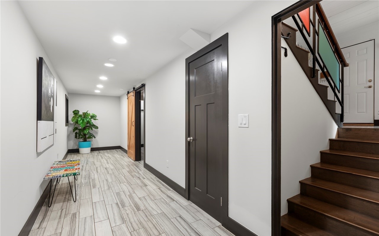 Finished basement with media area, bar, and recessed lighting
