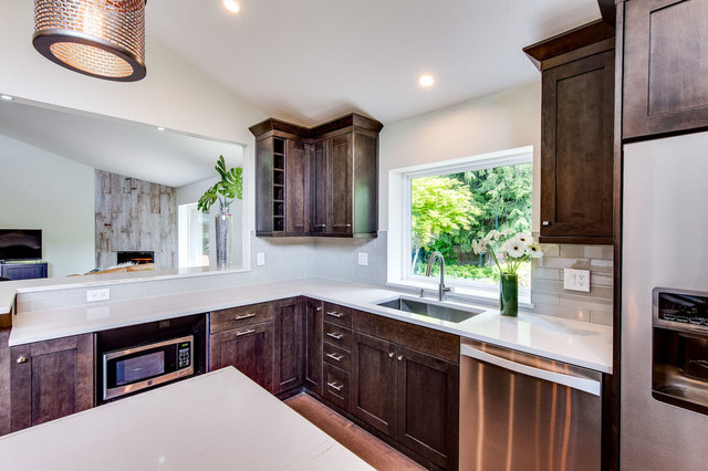U-shaped walnut kitchen with quartz counters, undermount sink, and garden window