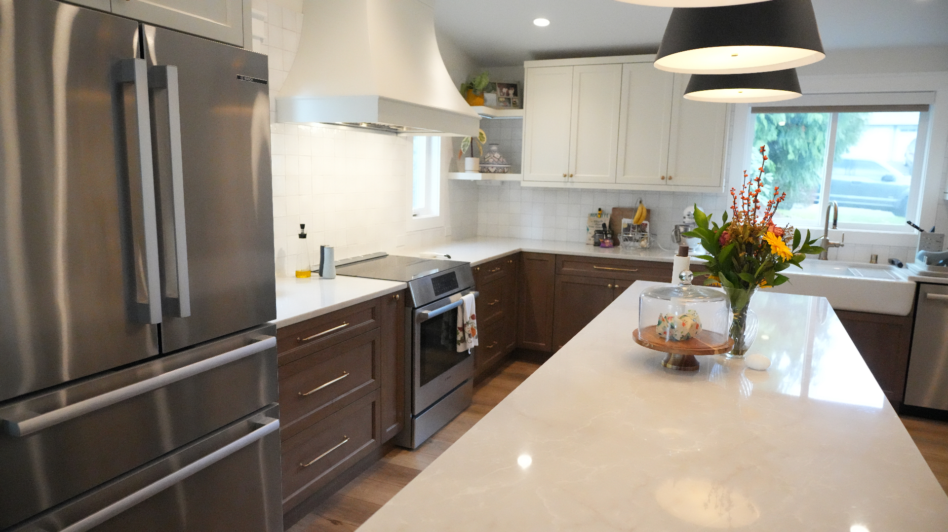 Bellevue kitchen with custom hood, refrigerator wall, and oversized quartz island