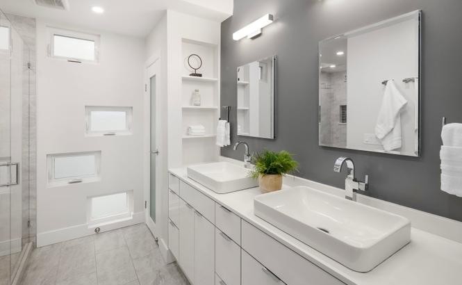 Primary bath with dual vessel-sink floating vanity and built-in shelving