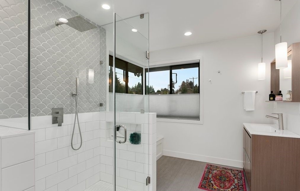 Custom walk-in closet with built-in dressers, hanging rods, and seating