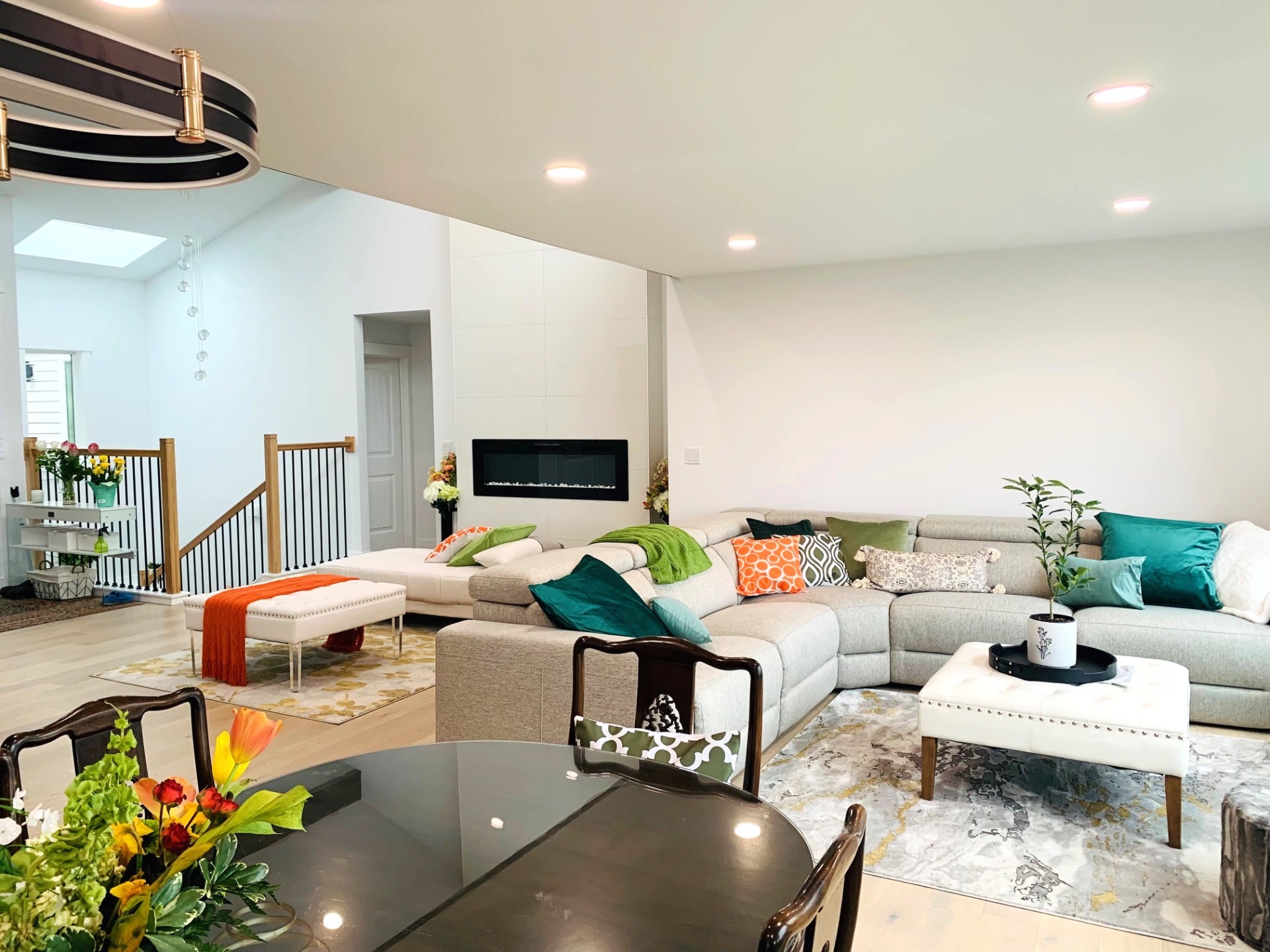 Spacious living room with sectional sofa, accent pillows, and modern fireplace