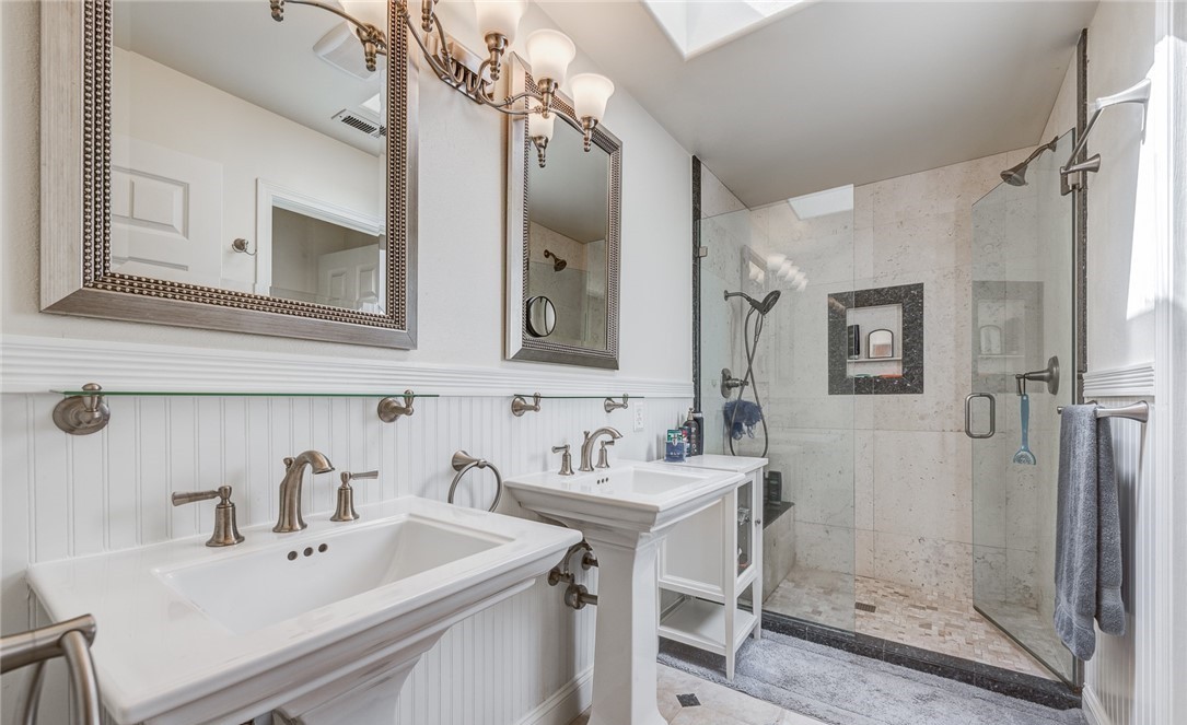Premium bathroom remodel highlighting walk-in shower, freestanding tub, custom tile, vanity, and lighting
