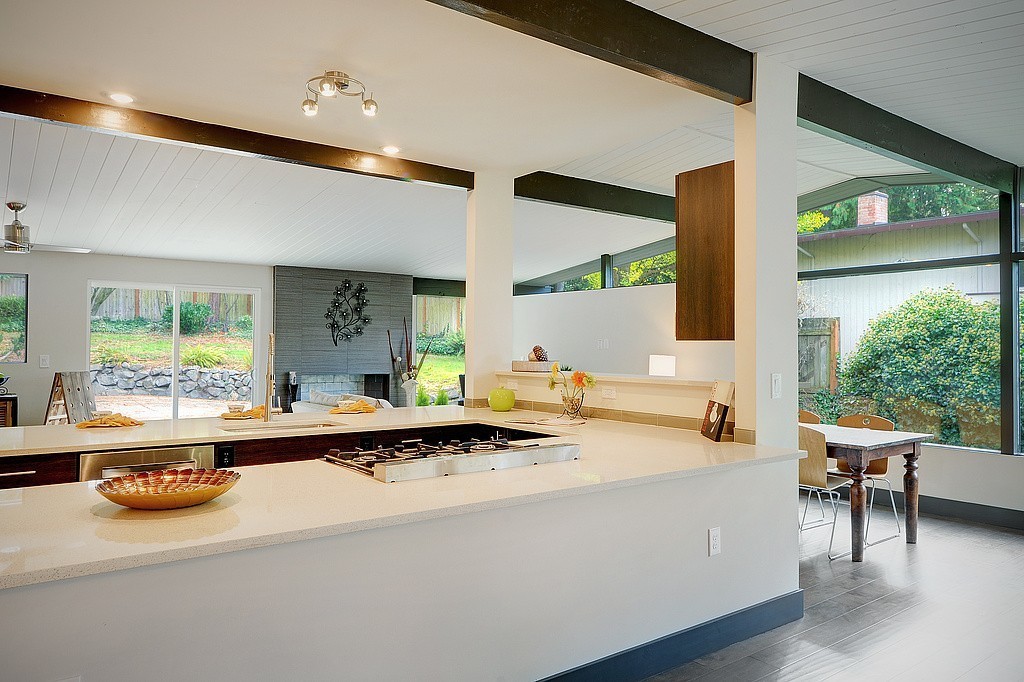 Open-concept living and kitchen with fireplace and chandelier