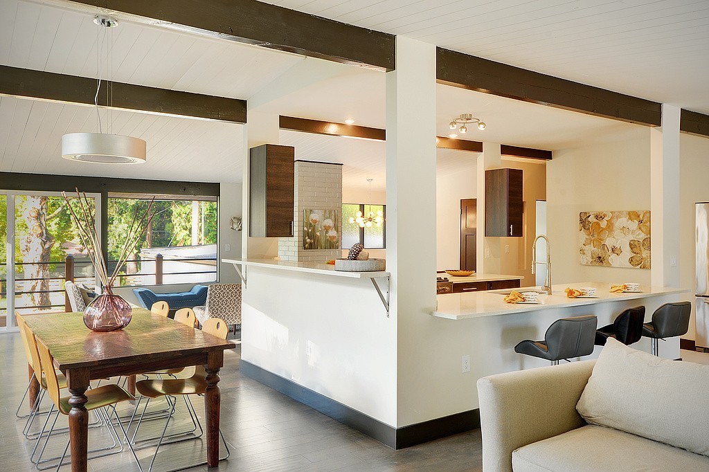 Dining room and breakfast bar with walnut cabinetry and natural light