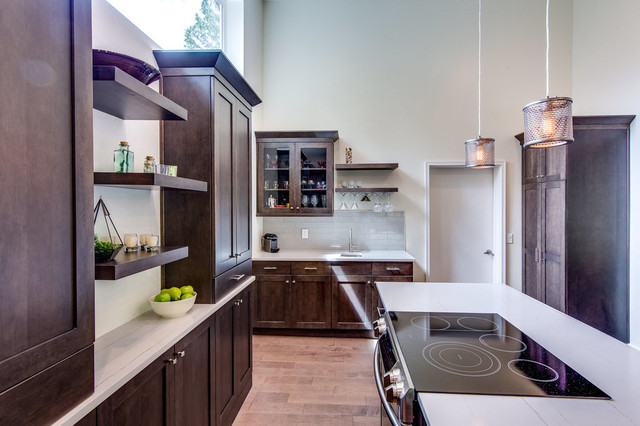 Walnut pantry wall with open shelving, glass cabinets, and induction cooktop on island