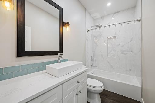 Renovated guest bathroom with custom tile and vanity