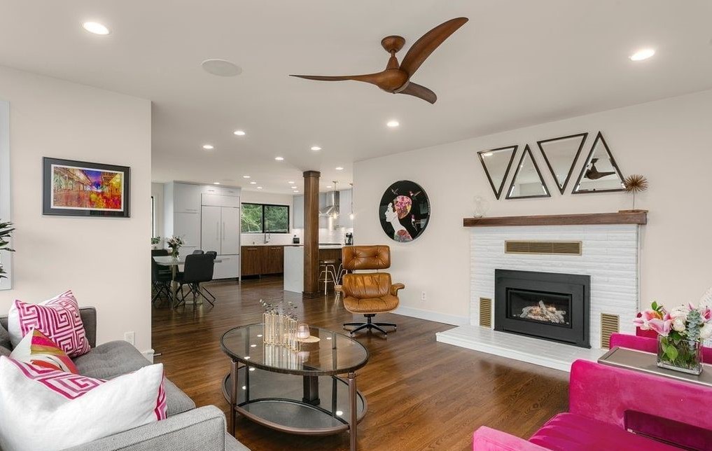 Modern living room with fireplace, built-ins, and oversized windows