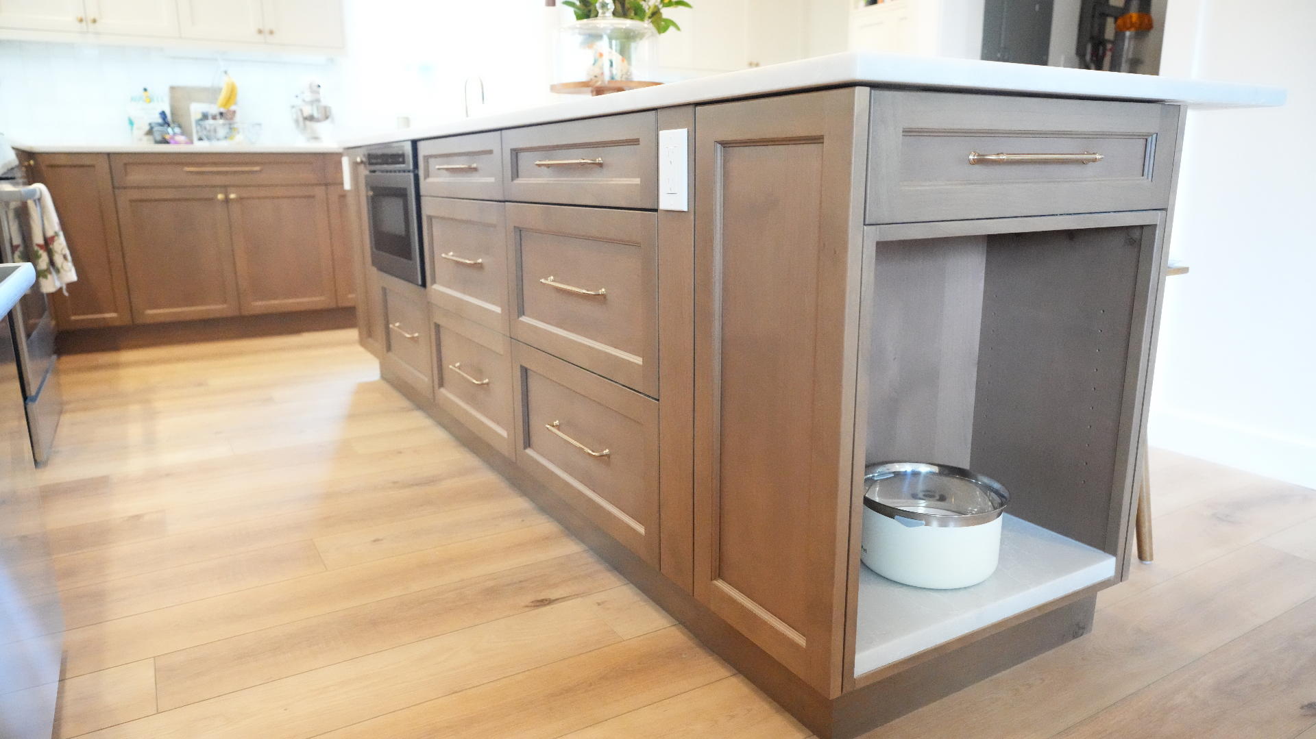 Island storage detailing with shaker panels and polished hardware in Bellevue kitchen