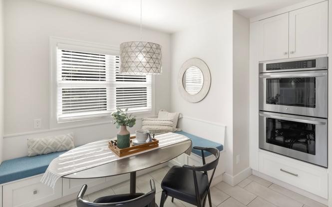 Breakfast nook with built-in banquette and double wall ovens